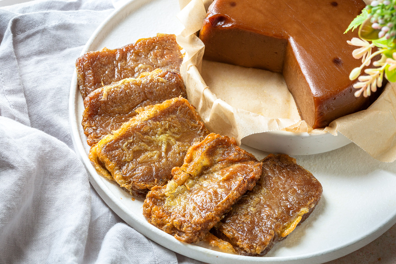 Chinese sweet rice cake - aka nian gao- steamed then pan-fried with egg coating.