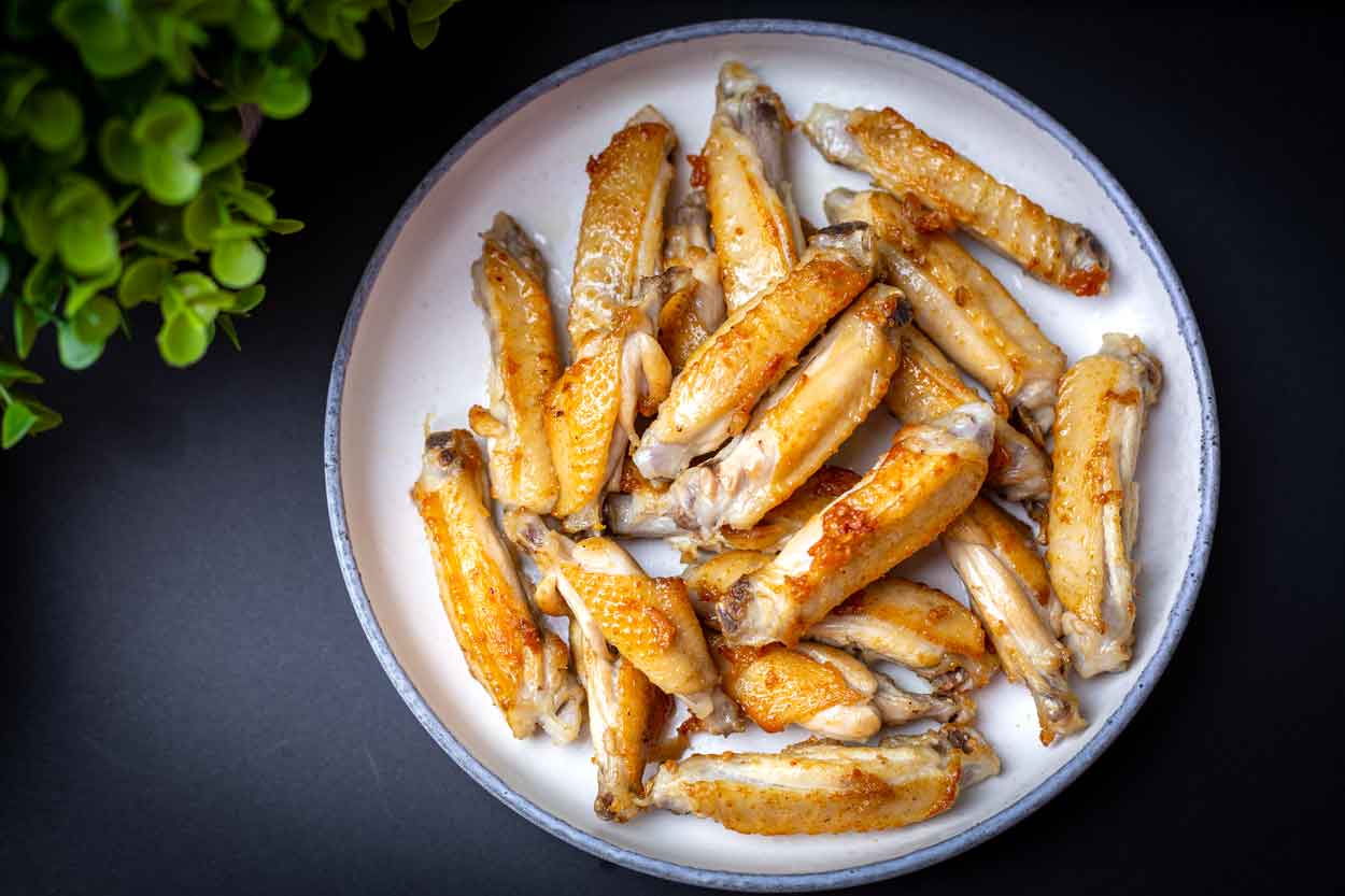 Pan fried chicken wings. wings are cut into halves.