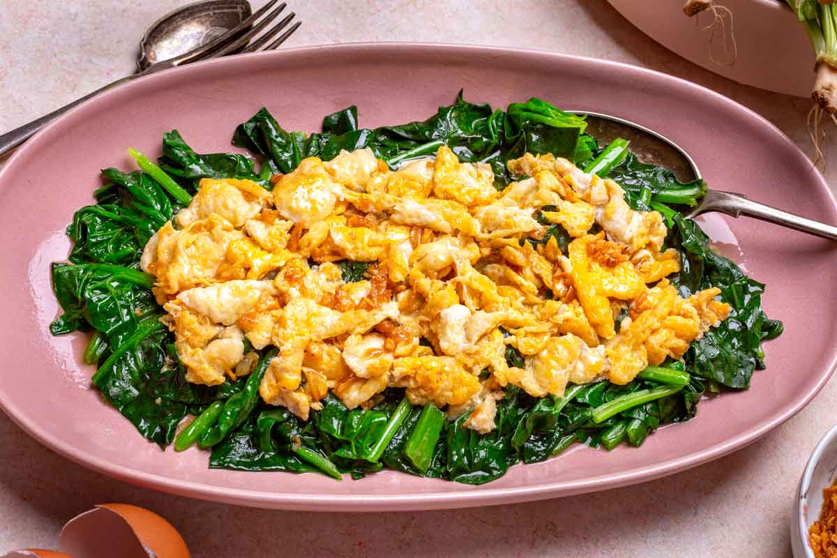 Fried Eggs on the top of Spinach in a pink plate